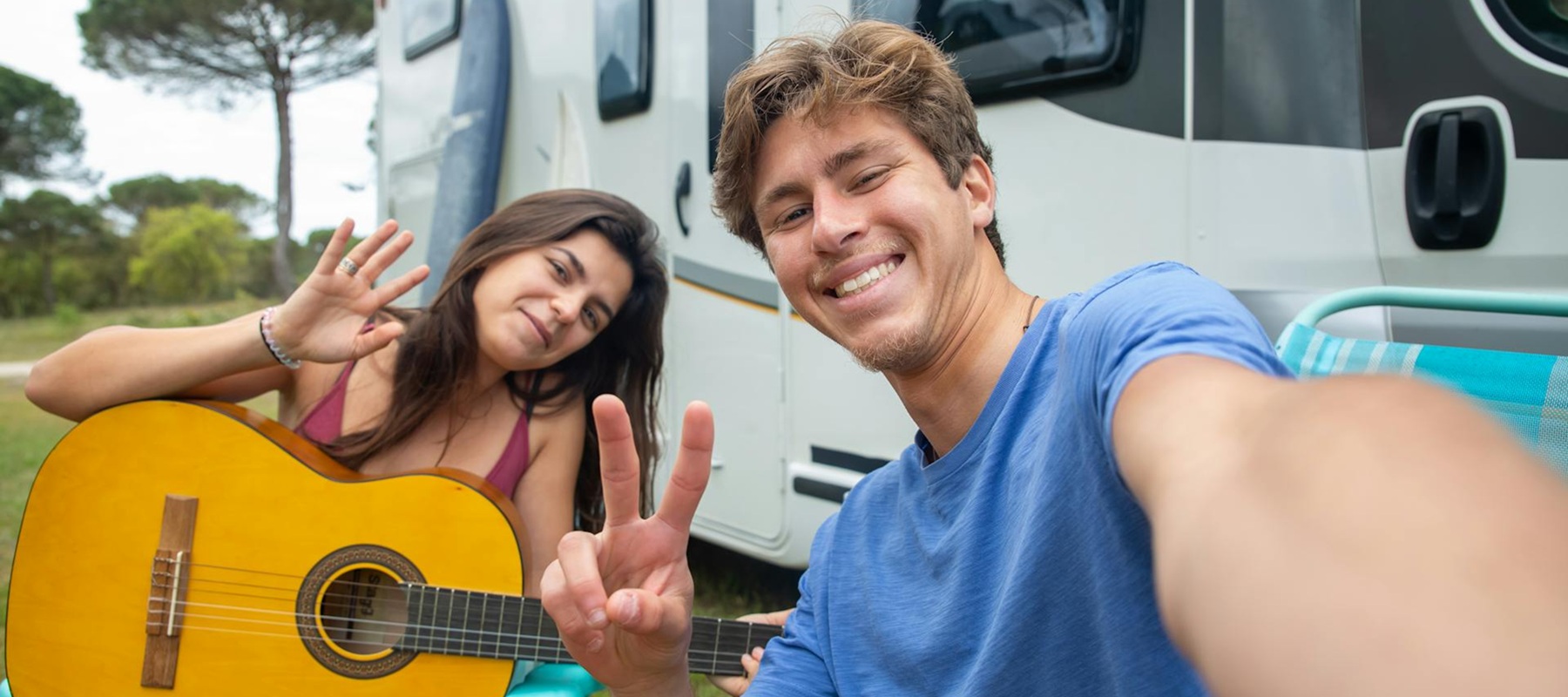 Couple sitting together on couch looking at laptop