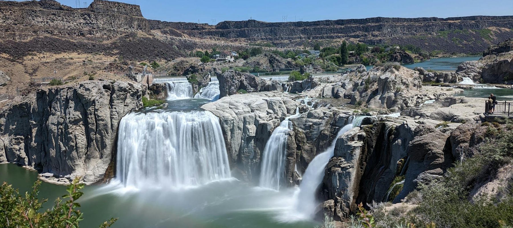 Couple sitting together on couch looking at laptop